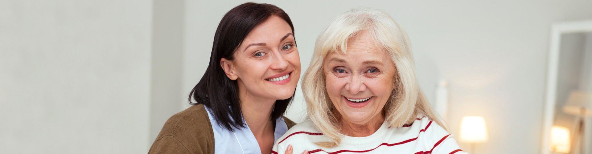 caregiver and a senior smiling