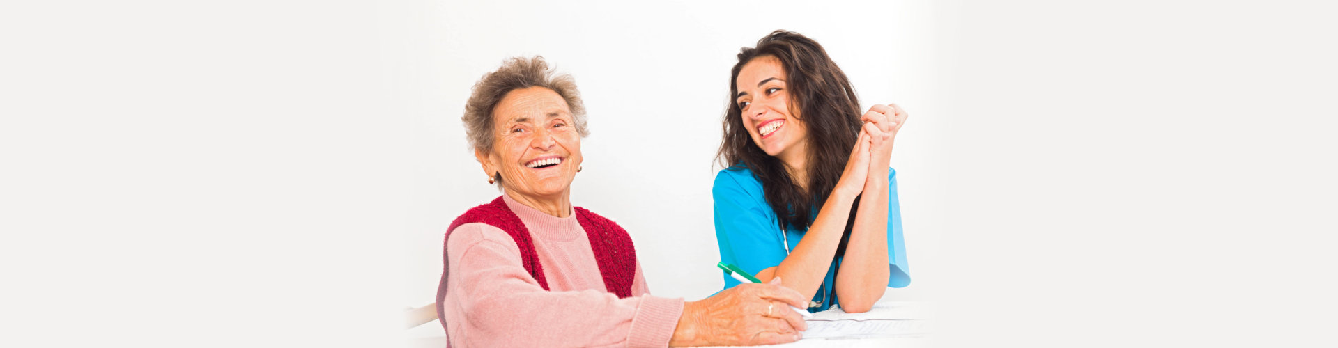 nurse and a caregiver smiling